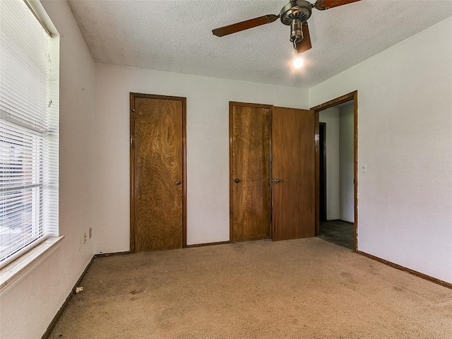 14601 Prairie Ln, Oklahoma City, OK 73165 - unfurnished bedroom with carpet flooring, a textured ceiling, and a ceiling fan