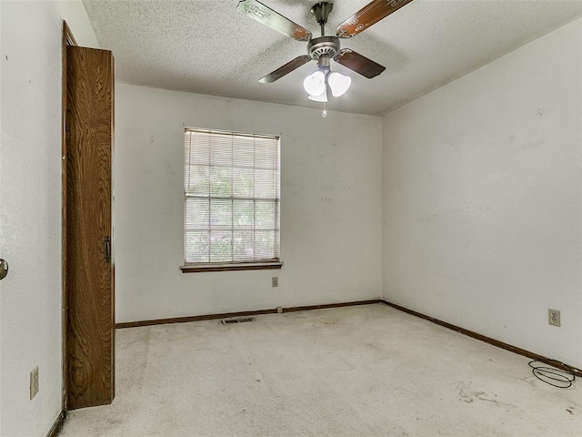 14601 Prairie Ln, Oklahoma City, OK 73165 - empty room with ceiling fan, carpet floors, and a textured ceiling