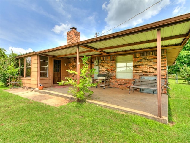 14601 Prairie Ln, Oklahoma City, OK 73165 - rear view of property with a chimney, a patio, and a yard
