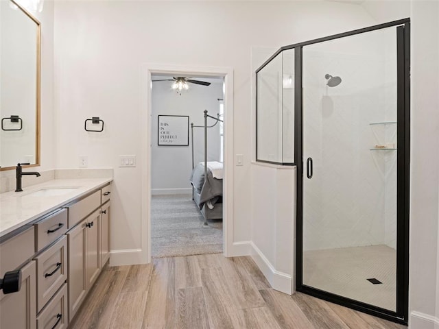408 Nantucket Blvd, Norman, OK 73071 - full bath featuring wood finished floors, vanity, ceiling fan, connected bathroom, and a shower stall