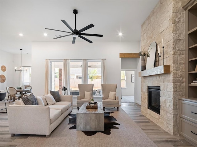 408 Nantucket Blvd, Norman, OK 73071 - living area featuring wood finished floors, a fireplace, a ceiling fan, recessed lighting, and a chandelier