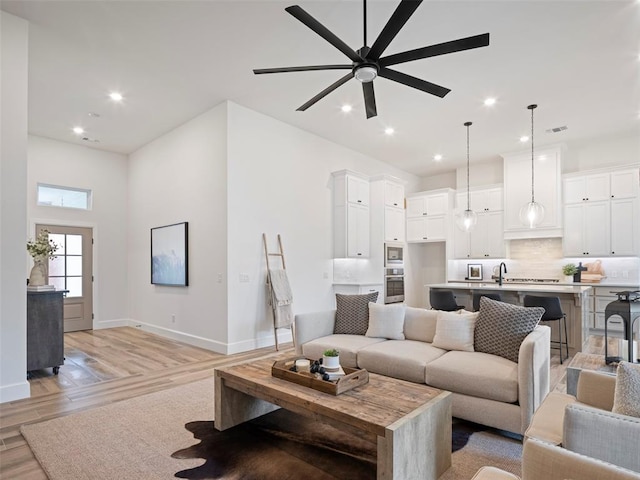 408 Nantucket Blvd, Norman, OK 73071 - living room featuring ceiling fan, light wood finished floors, and recessed lighting