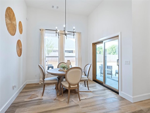 408 Nantucket Blvd, Norman, OK 73071 - dining space with a chandelier, light wood finished floors, and a high ceiling