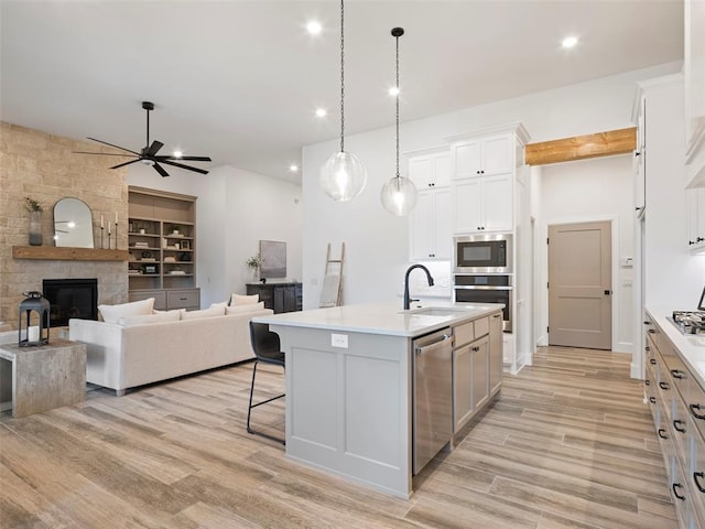 408 Nantucket Blvd, Norman, OK 73071 - kitchen featuring appliances with stainless steel finishes, light countertops, ceiling fan, light wood-type flooring, and recessed lighting