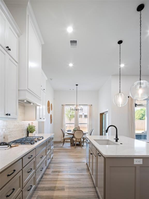 408 Nantucket Blvd, Norman, OK 73071 - kitchen with stainless steel appliances, healthy amount of natural light, light wood finished floors, a center island with sink, and recessed lighting
