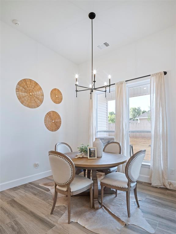 408 Nantucket Blvd, Norman, OK 73071 - dining space with a chandelier and light wood-style floors