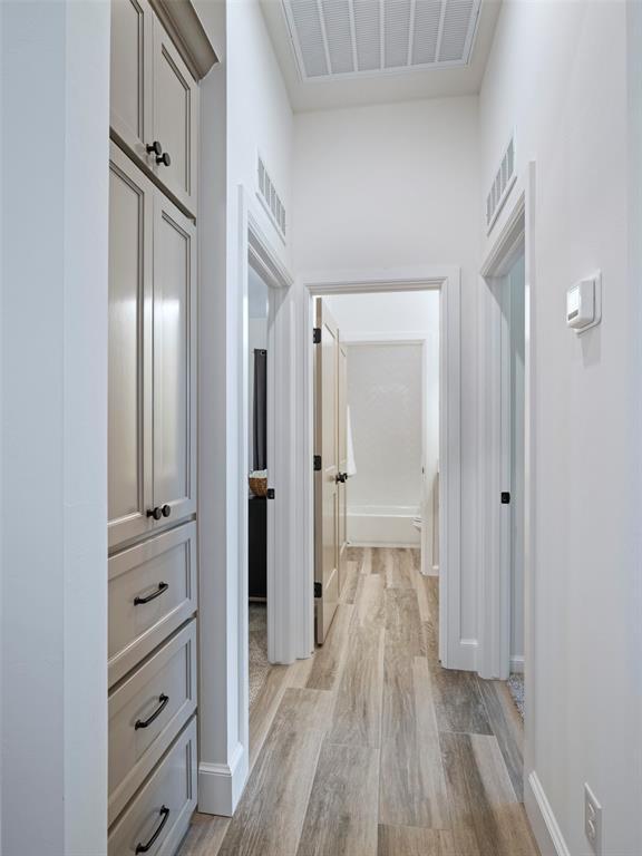 408 Nantucket Blvd, Norman, OK 73071 - corridor with light wood finished floors and baseboards