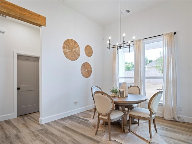 408 Nantucket Blvd, Norman, OK 73071 - dining space featuring a chandelier, light wood-style flooring, and a towering ceiling