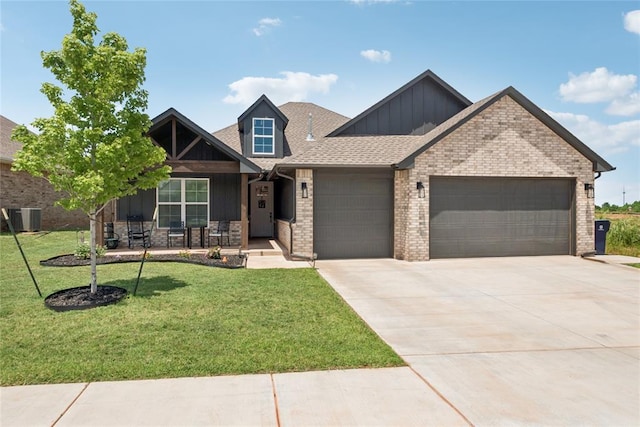 10413 SW 51st St, Mustang, OK 73064 - craftsman-style house with board and batten siding, an attached garage, covered porch, a front yard, and driveway