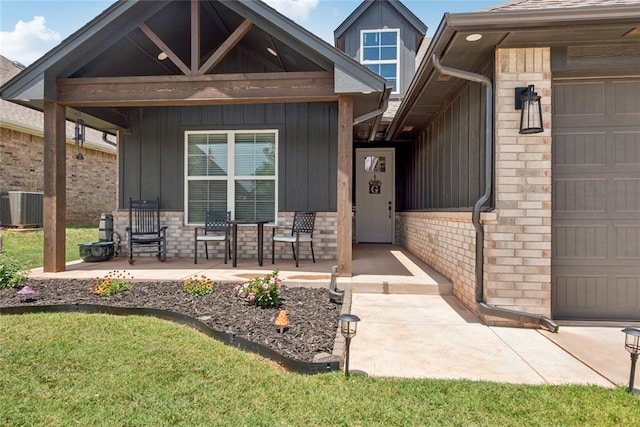 10413 SW 51st St, Mustang, OK 73064 - property entrance featuring a porch, board and batten siding, a garage, brick siding, and a lawn