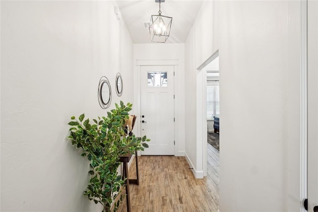 10413 SW 51st St, Mustang, OK 73064 - doorway featuring light wood-type flooring and a chandelier