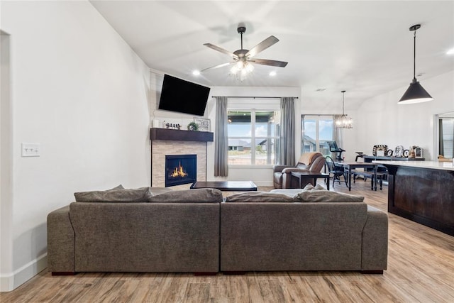 10413 SW 51st St, Mustang, OK 73064 - living area featuring a stone fireplace, light wood-style floors, a ceiling fan, a chandelier, and recessed lighting