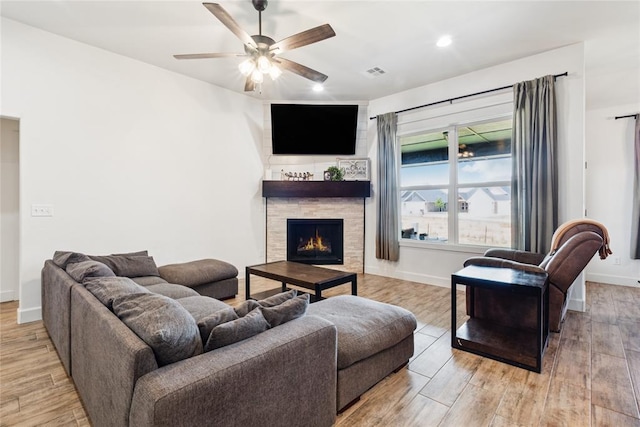 10413 SW 51st St, Mustang, OK 73064 - living room with light wood-style floors, a ceiling fan, a tile fireplace, and recessed lighting
