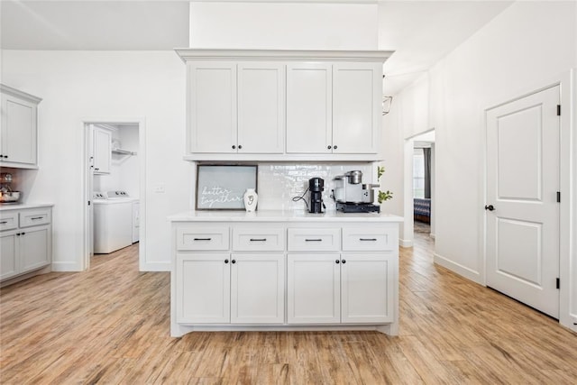 10413 SW 51st St, Mustang, OK 73064 - kitchen featuring independent washer and dryer, decorative backsplash, light countertops, and light wood-type flooring