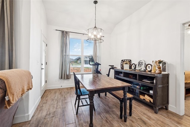 10413 SW 51st St, Mustang, OK 73064 - dining area featuring vaulted ceiling, wood finished floors, and a chandelier