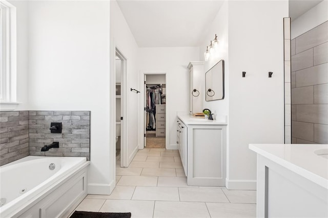 10413 SW 51st St, Mustang, OK 73064 - bathroom with vanity, a tub with jets, tile patterned floors, and a walk in closet