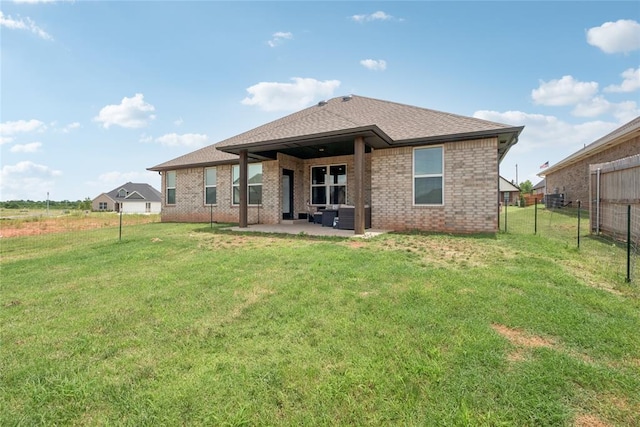 10413 SW 51st St, Mustang, OK 73064 - back of property featuring an outdoor living space, a patio, roof with shingles, and brick siding