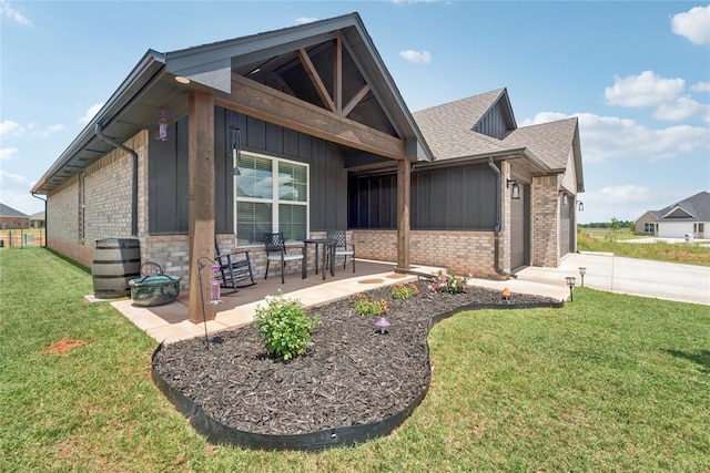 10413 SW 51st St, Mustang, OK 73064 - view of front facade with brick siding, a front yard, board and batten siding, roof with shingles, and an attached garage