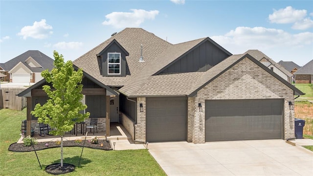 10413 SW 51st St, Mustang, OK 73064 - view of front of property featuring an attached garage, board and batten siding, driveway, a front lawn, and a shingled roof