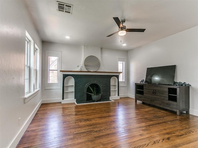 2016 Hardin Dr, Oklahoma City, OK 73111 - living area with plenty of natural light, a fireplace with raised hearth, wood finished floors, and ceiling fan