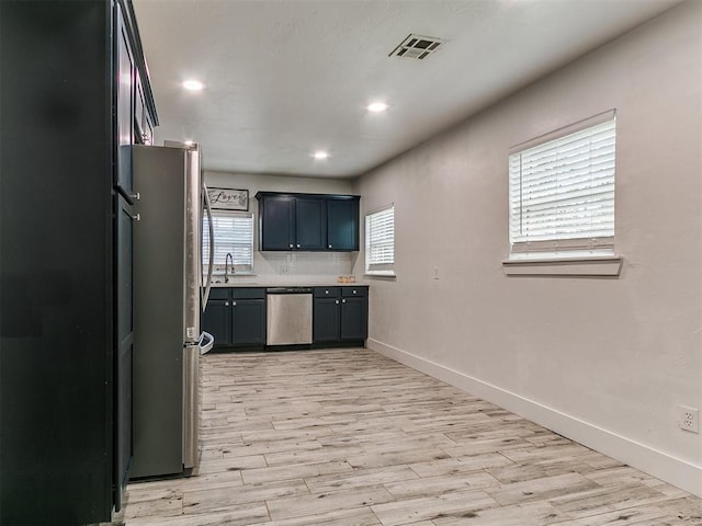 2016 Hardin Dr, Oklahoma City, OK 73111 - kitchen featuring stainless steel appliances, light wood finished floors, light countertops, recessed lighting, and decorative backsplash