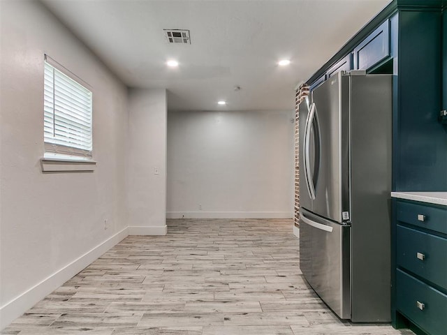 2016 Hardin Dr, Oklahoma City, OK 73111 - kitchen featuring freestanding refrigerator, light wood-style flooring, recessed lighting, green cabinetry, and light countertops