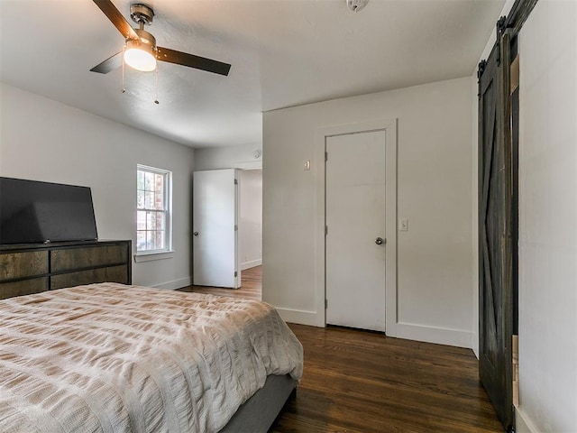 2016 Hardin Dr, Oklahoma City, OK 73111 - bedroom featuring wood finished floors, a barn door, and a ceiling fan