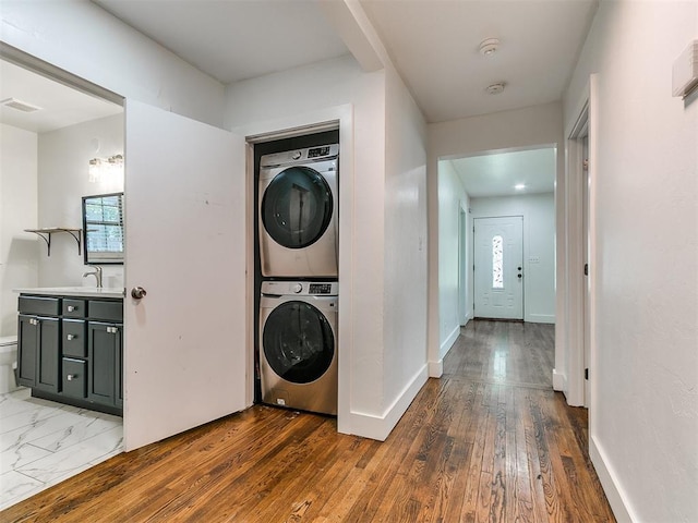 2016 Hardin Dr, Oklahoma City, OK 73111 - washroom with estacked washer and dryer and hardwood / wood-style floors