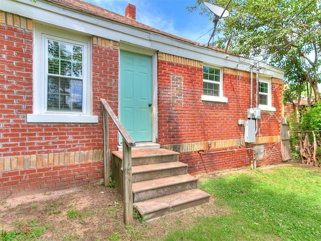 2016 Hardin Dr, Oklahoma City, OK 73111 - entrance to property featuring brick siding, a chimney, and a yard