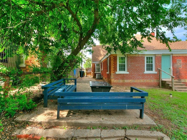 2016 Hardin Dr, Oklahoma City, OK 73111 - back of property featuring brick siding, entry steps, and a shingled roof
