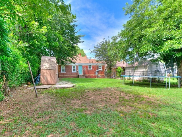 2016 Hardin Dr, Oklahoma City, OK 73111 - view of grassy yard with a trampoline and a shed