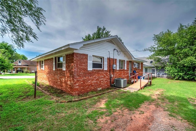 420 E 12th St, Chandler, OK 74834 - view of side of home with a lawn and brick siding