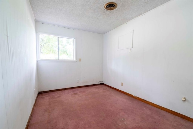 420 E 12th St, Chandler, OK 74834 - spare room featuring a textured ceiling and carpet flooring