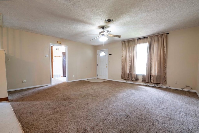 420 E 12th St, Chandler, OK 74834 - unfurnished living room featuring ceiling fan, a textured ceiling, and carpet