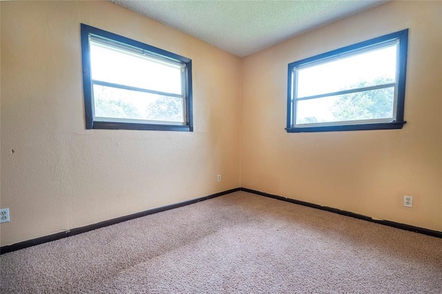 420 E 12th St, Chandler, OK 74834 - unfurnished room with carpet flooring and a textured ceiling