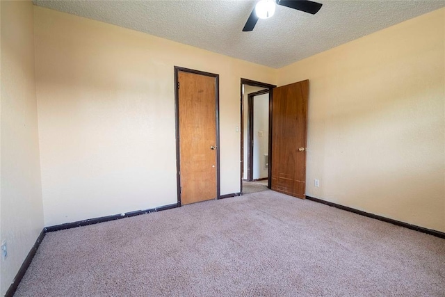 420 E 12th St, Chandler, OK 74834 - unfurnished room featuring carpet floors, a textured ceiling, and a ceiling fan