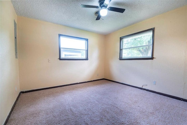 420 E 12th St, Chandler, OK 74834 - carpeted empty room with plenty of natural light, a textured ceiling, and ceiling fan