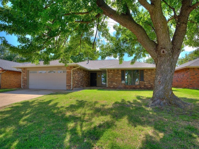 8317 Curtis Ter, Oklahoma City, OK 73132 - single story home with a garage, concrete driveway, brick siding, and a front lawn