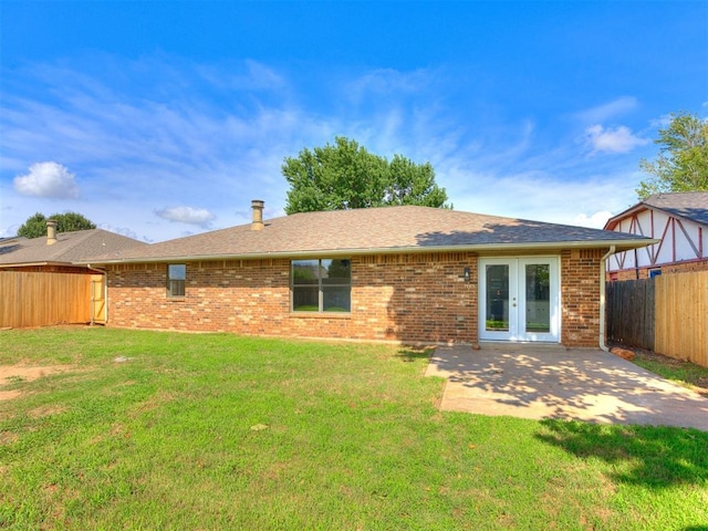 8317 Curtis Ter, Oklahoma City, OK 73132 - back of property with a fenced backyard, french doors, a patio area, and brick siding