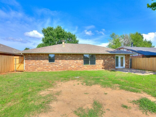 8317 Curtis Ter, Oklahoma City, OK 73132 - rear view of property featuring french doors, brick siding, roof with shingles, and a patio