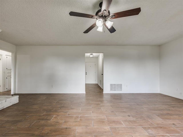 8317 Curtis Ter, Oklahoma City, OK 73132 - empty room with wood finished floors, a ceiling fan, and a textured ceiling