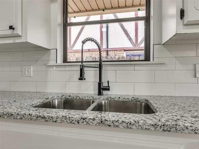 8317 Curtis Ter, Oklahoma City, OK 73132 - kitchen view of tasteful backsplash, white cabinets, and light stone countertops