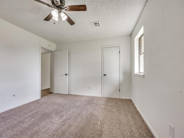8317 Curtis Ter, Oklahoma City, OK 73132 - unfurnished bedroom featuring a textured ceiling, carpet, and ceiling fan