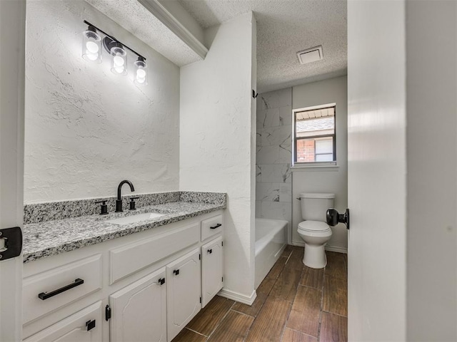 8317 Curtis Ter, Oklahoma City, OK 73132 - bathroom with a textured ceiling, vanity, shower / bathtub combination, wood finished floors, and a textured wall