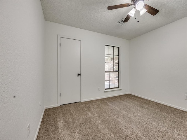 8317 Curtis Ter, Oklahoma City, OK 73132 - carpeted spare room with a textured ceiling and a ceiling fan