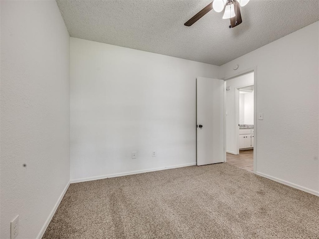 8317 Curtis Ter, Oklahoma City, OK 73132 - unfurnished room with light colored carpet, ceiling fan, and a textured ceiling
