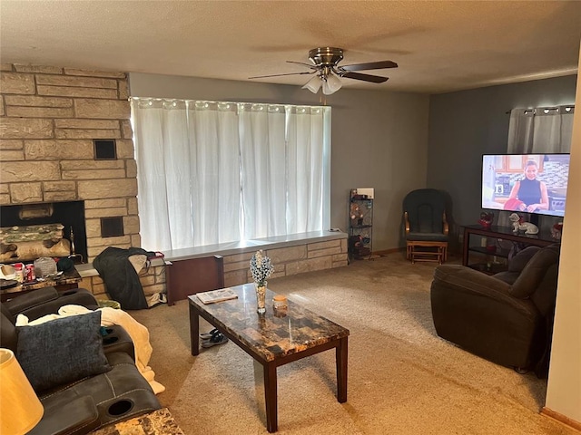 601 N Broadway St, Hobart, OK 73651 - carpeted living room with ceiling fan, a textured ceiling, and a fireplace