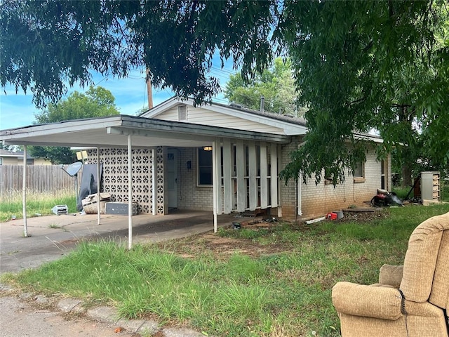 601 N Broadway St, Hobart, OK 73651 - view of front of property with a carport, brick siding, and concrete driveway