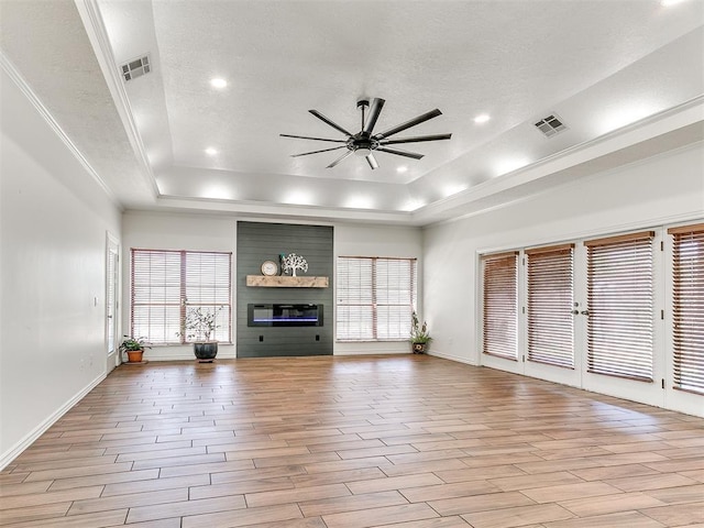 620 SW 113th St, Oklahoma City, OK 73170 - unfurnished living room with a raised ceiling, ceiling fan, light wood finished floors, recessed lighting, and a textured ceiling