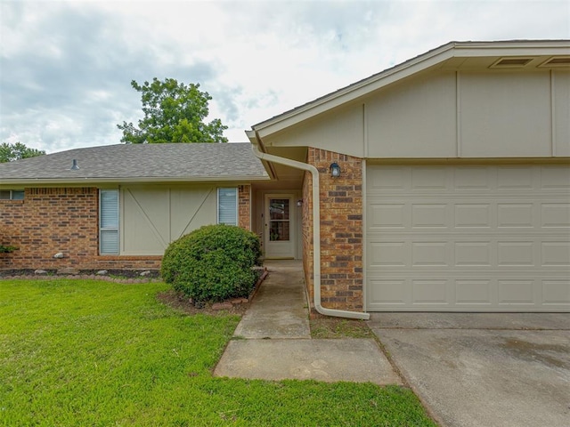 10428 Fairfax Ln, Yukon, OK 73099 - view of front facade with brick siding, a front yard, an attached garage, and driveway